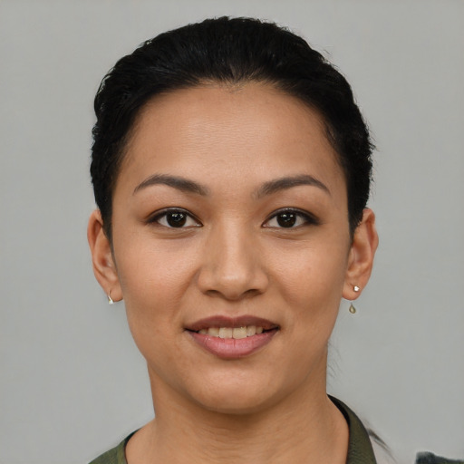Joyful latino young-adult female with short  black hair and brown eyes