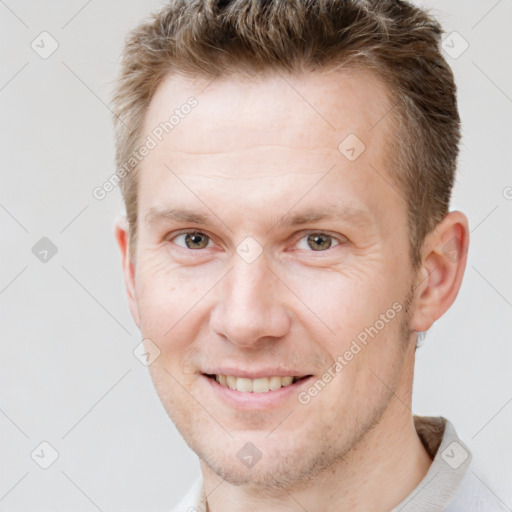 Joyful white adult male with short  brown hair and brown eyes