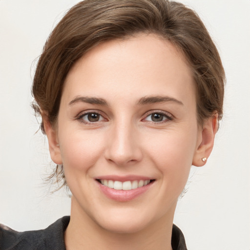 Joyful white young-adult female with medium  brown hair and grey eyes