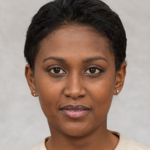 Joyful latino young-adult female with short  black hair and brown eyes