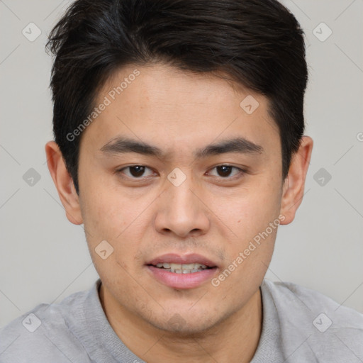 Joyful asian young-adult male with short  brown hair and brown eyes