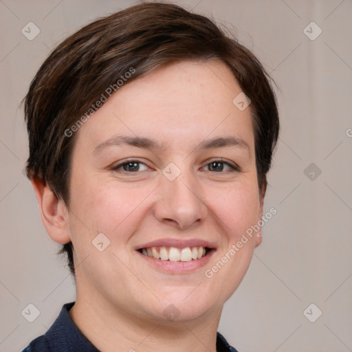 Joyful white young-adult female with short  brown hair and grey eyes