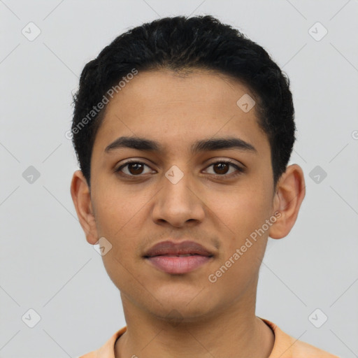 Joyful latino young-adult male with short  black hair and brown eyes