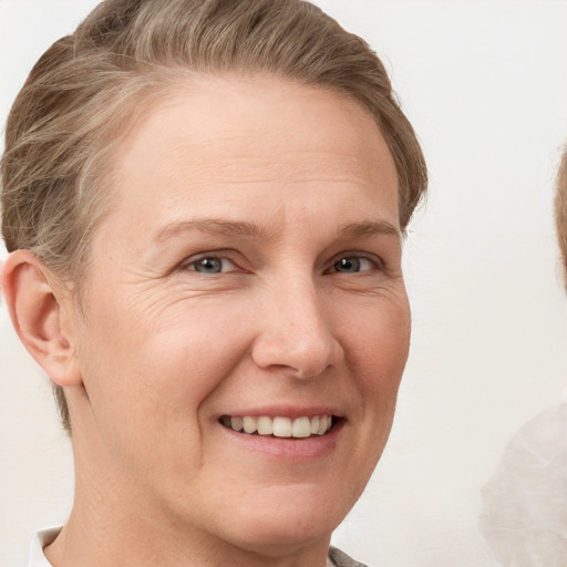 Joyful white adult female with short  brown hair and grey eyes