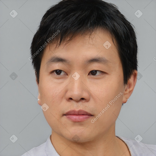 Joyful asian young-adult male with short  black hair and brown eyes