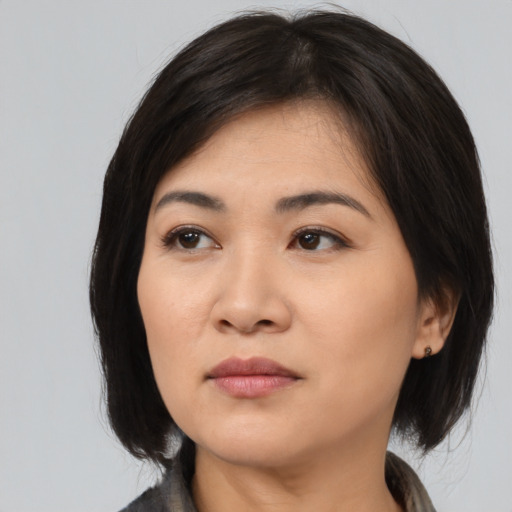 Joyful asian young-adult female with medium  black hair and brown eyes