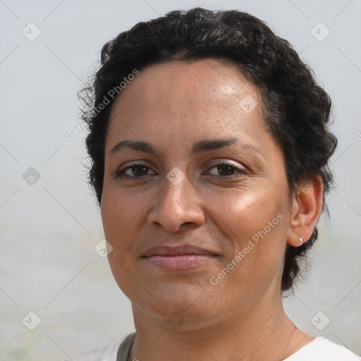 Joyful latino adult female with short  brown hair and brown eyes