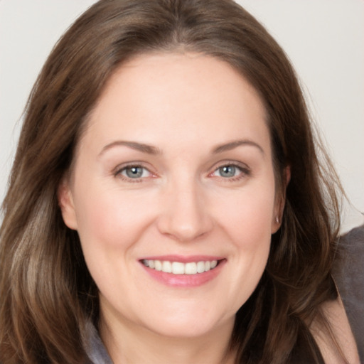 Joyful white young-adult female with long  brown hair and grey eyes