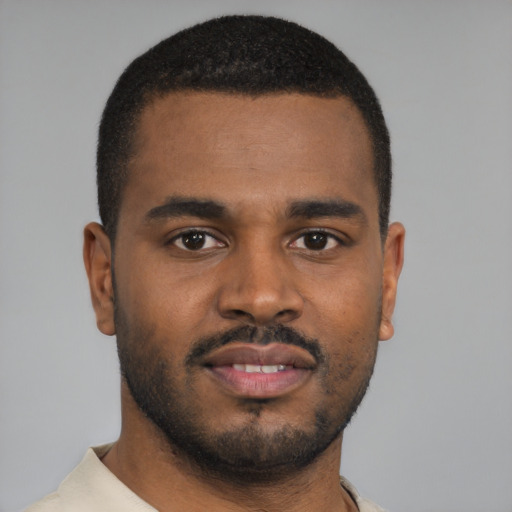 Joyful black young-adult male with short  brown hair and brown eyes
