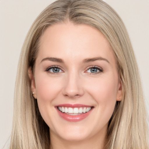 Joyful white young-adult female with long  brown hair and blue eyes