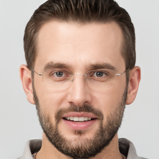 Joyful white adult male with short  brown hair and brown eyes