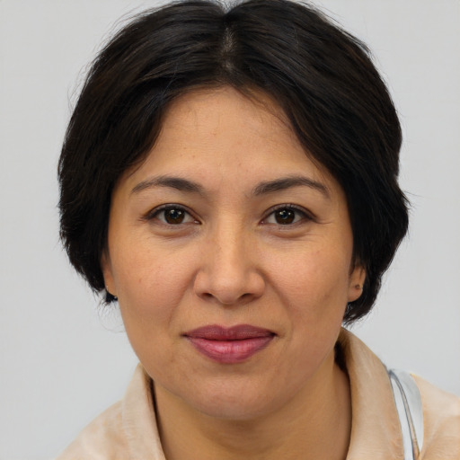 Joyful asian adult female with medium  brown hair and brown eyes