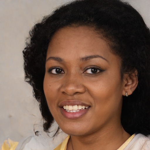 Joyful black young-adult female with medium  black hair and brown eyes