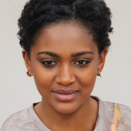 Joyful black young-adult female with short  black hair and brown eyes