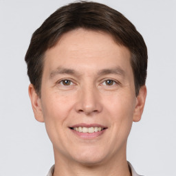 Joyful white adult male with short  brown hair and brown eyes