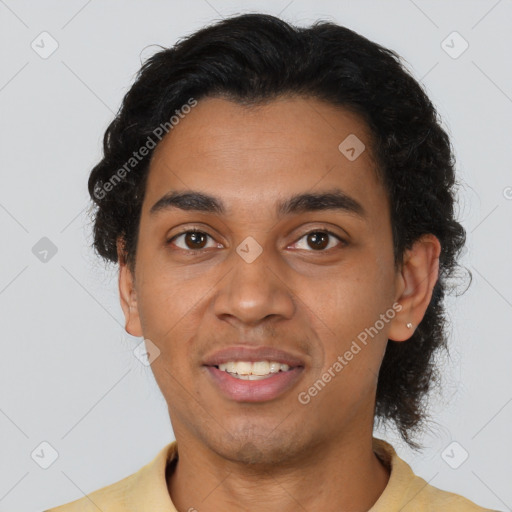 Joyful latino young-adult male with short  brown hair and brown eyes