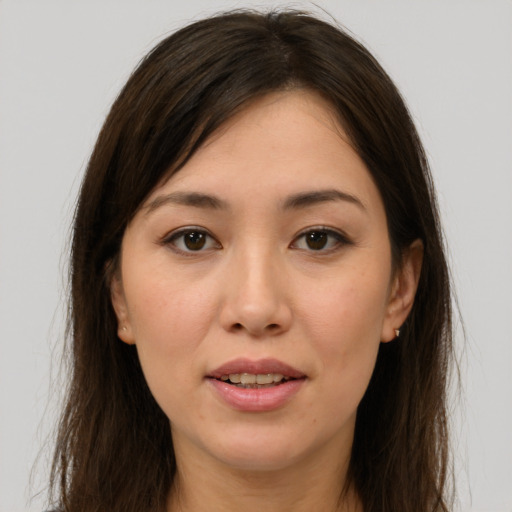Joyful white young-adult female with long  brown hair and brown eyes