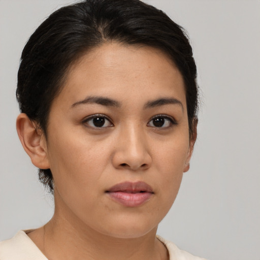 Joyful latino young-adult female with short  brown hair and brown eyes