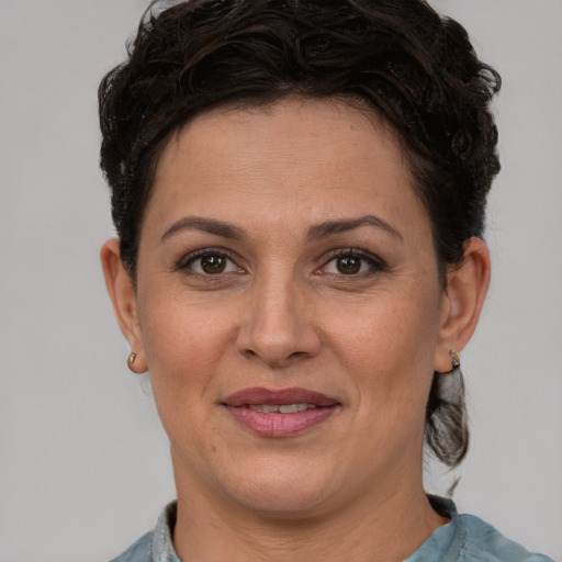 Joyful white adult female with short  brown hair and brown eyes