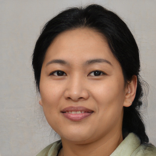 Joyful asian adult female with medium  black hair and brown eyes