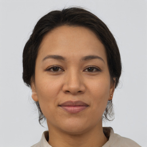 Joyful latino young-adult female with medium  brown hair and brown eyes