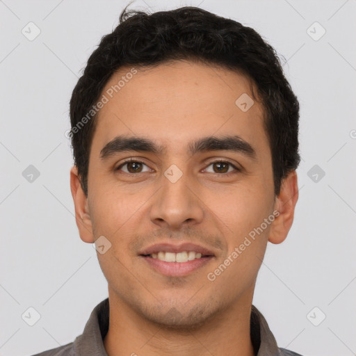 Joyful white young-adult male with short  black hair and brown eyes