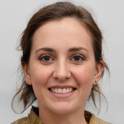 Joyful white young-adult female with medium  brown hair and grey eyes