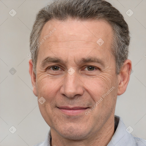 Joyful white middle-aged male with short  brown hair and brown eyes