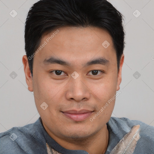 Joyful asian young-adult male with short  brown hair and brown eyes