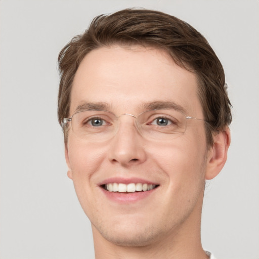 Joyful white young-adult male with short  brown hair and green eyes