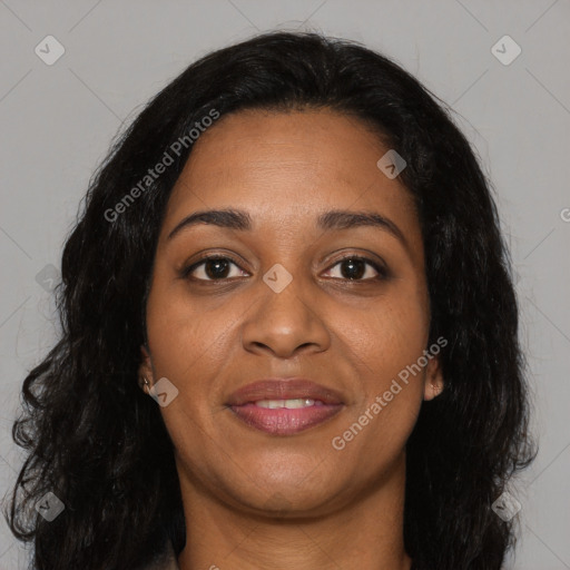 Joyful black young-adult female with long  brown hair and brown eyes