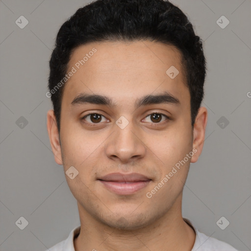 Joyful latino young-adult male with short  black hair and brown eyes