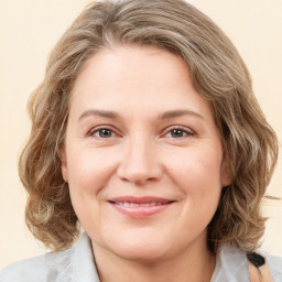 Joyful white adult female with medium  brown hair and brown eyes