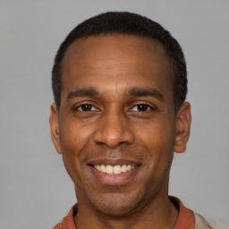 Joyful latino adult male with short  black hair and brown eyes