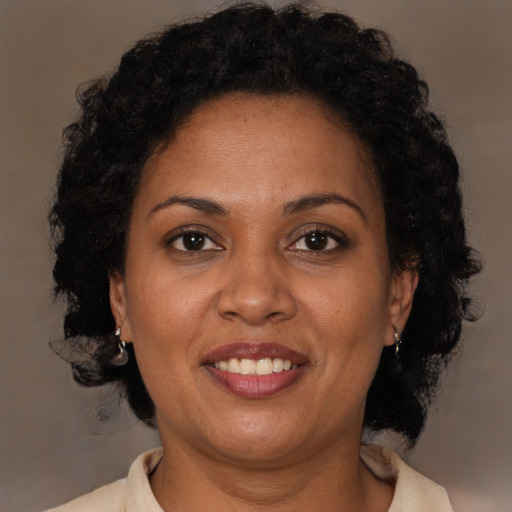 Joyful latino adult female with medium  brown hair and brown eyes