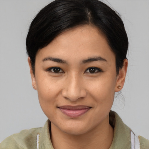 Joyful asian young-adult female with medium  brown hair and brown eyes