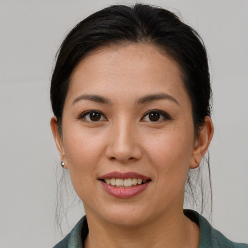 Joyful asian young-adult female with medium  brown hair and brown eyes