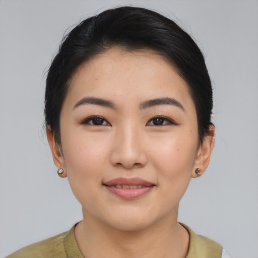 Joyful asian young-adult female with short  black hair and brown eyes