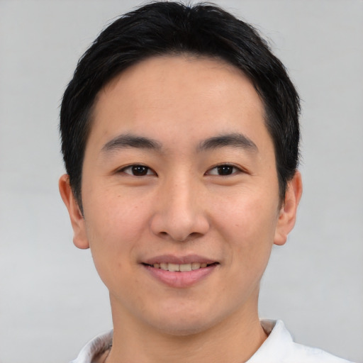 Joyful asian young-adult male with short  brown hair and brown eyes
