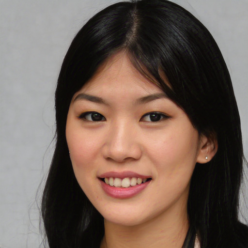 Joyful asian young-adult female with long  black hair and brown eyes