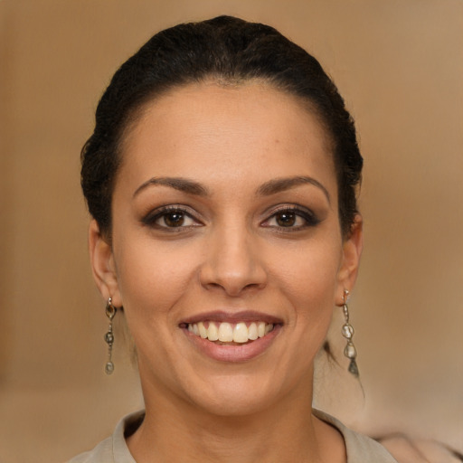 Joyful latino young-adult female with short  brown hair and brown eyes