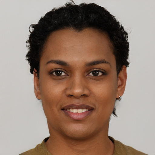 Joyful black young-adult female with short  black hair and brown eyes