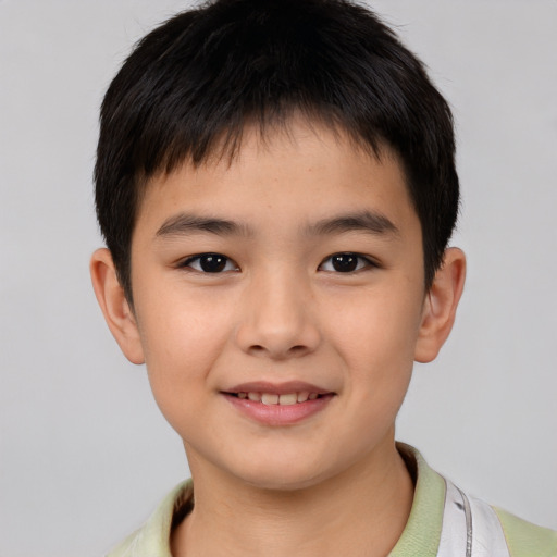 Joyful asian child male with short  brown hair and brown eyes