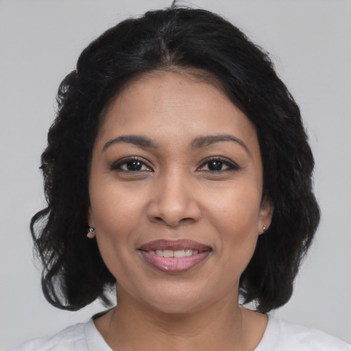 Joyful latino young-adult female with medium  black hair and brown eyes