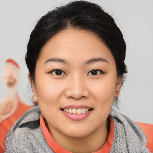 Joyful asian young-adult female with medium  brown hair and brown eyes