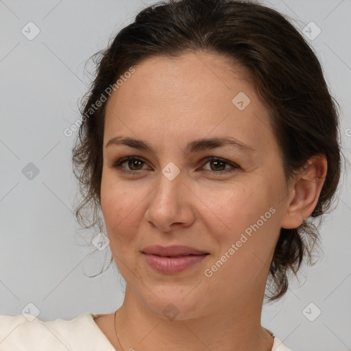 Joyful white adult female with medium  brown hair and brown eyes