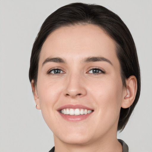 Joyful white young-adult female with medium  brown hair and brown eyes