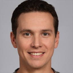 Joyful white young-adult male with short  brown hair and brown eyes