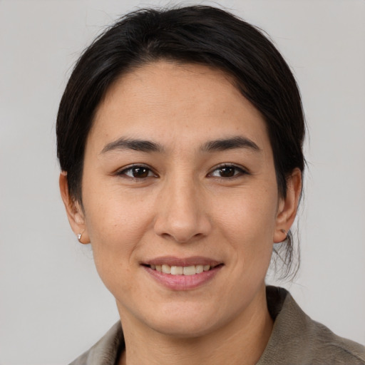 Joyful asian young-adult female with medium  brown hair and brown eyes