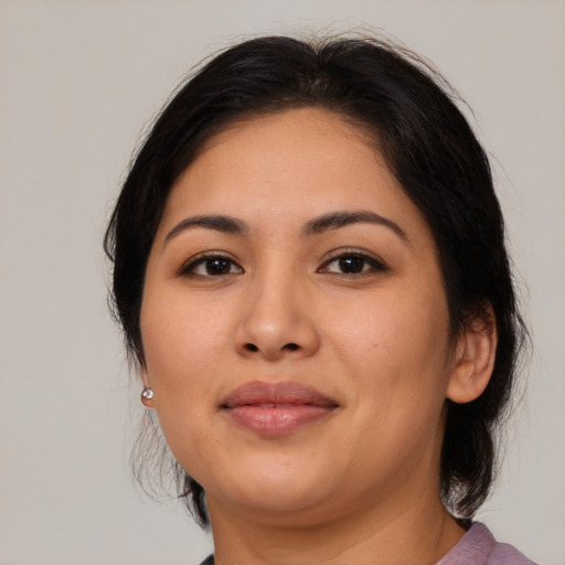 Joyful latino young-adult female with medium  brown hair and brown eyes